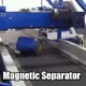 A Magnetic Separator selects a heavy drum and moves it into a metals skip for recycling.