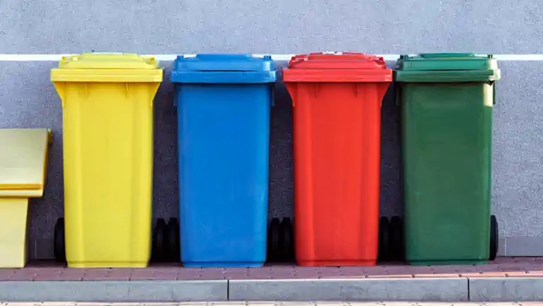 Wheelie bins ready for the trash collection company collection.