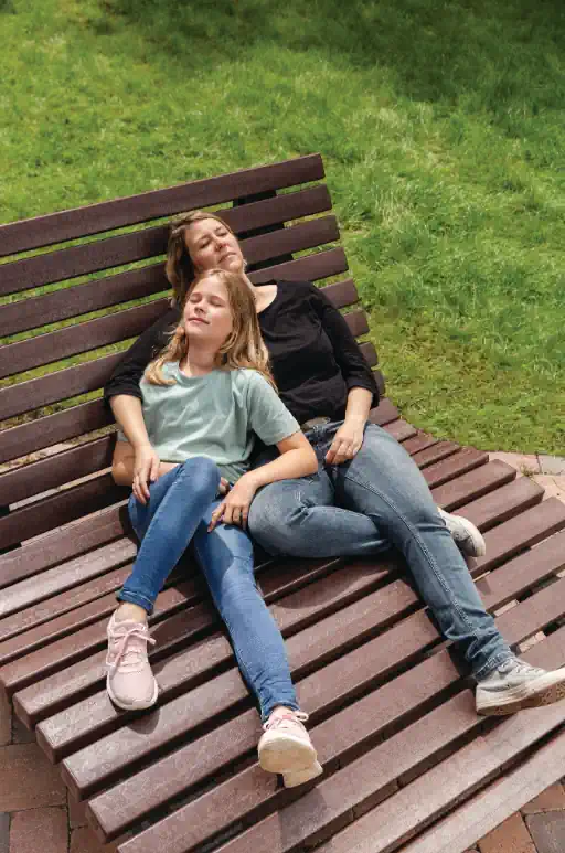 A family enjoys a relaxed picnic around a sturdy recycled plastic garden furniture